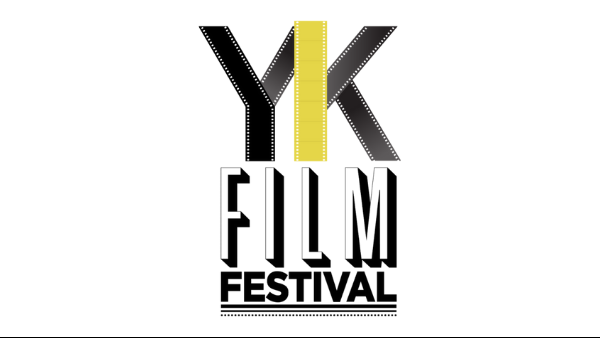 Logo of the Yellowknife International Film Festival. The words “YK”, “Film” and “Festival” are written one above the other, in three lines. All capital letters. All black and white, except the “YK”. It is black and gold and made with film tape.